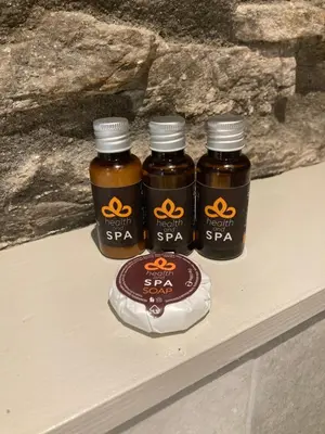 three bottles of honey sitting on a table at On Season 4 of BBC 1s BEYOND PARADISE - Prospect House is TWO PRIVATE APARTMENTS in this 17th CENTURY COTTAGE - Apartment 2 has a KIDS CABIN BUNK ROOM - Book both apartments for ONE LARGE HOUSE with Connecting Door In Lobby - FREE PUBLIC PARKING OUTSIDE in Looe