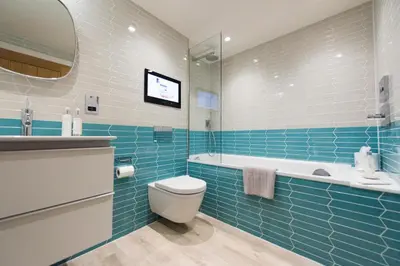 a bathroom with a toilet and a tub and a sink at Juliot 5 Star Gold Award Luxury Cottage in St Ives
