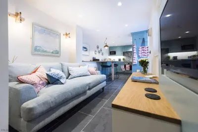 a living room with a couch and a table at The Garth 5 Star Gold Luxury Cottages in St Ives
