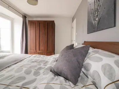 a bedroom with a bed with a pillow on it at The Lookout in Newquay