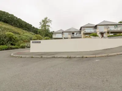 a curved road with houses in the background at The Bolt Hole in Torpoint
