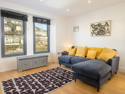 a living room with a couch and a rug at Water View in Looe