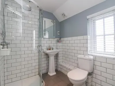 a bathroom with a toilet and a sink at Fistral Bay Cottage in Newquay