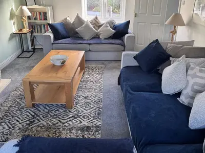 a living room with two couches and a coffee table at Fistral Bay Cottage in Newquay