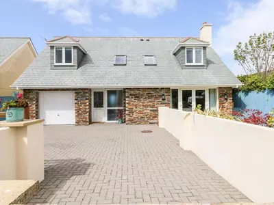 a brick house with a driveway in front of it at Trevose House in Newquay