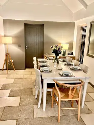 a dining room with a white table and chairs at Gwel an Heyl, Padstow in Little Petherick