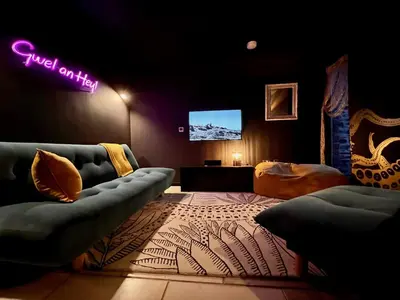 a living room with a couch and a tv at Gwel an Heyl, Padstow in Little Petherick