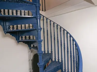 a blue spiral staircase in a room at Labour in Vain in St Ives