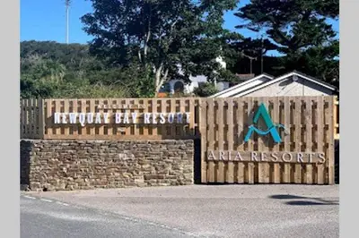 a wooden fence with an ak records sign on it at Premium Chalet at Newquay Away Resorts MV7 in Newquay
