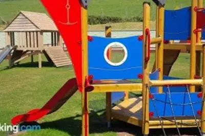 a playground with a slide in a park at Premium Chalet at Newquay Away Resorts MV7 in Newquay