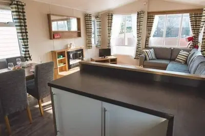 a large living room with a couch and a table at Premium Chalet at Newquay Away Resorts MV7 in Newquay