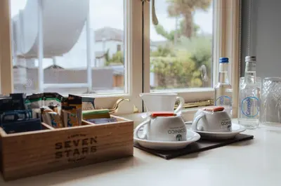 two tea cups on a counter next to a window at Seven Stars Penryn in Penryn