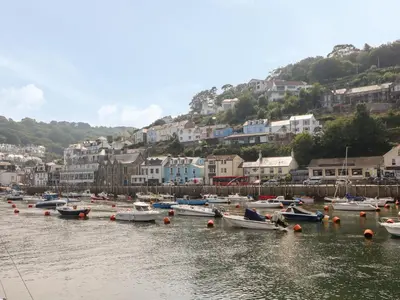 a bunch of boats are docked in a harbor at Pixie Cottage in Looe