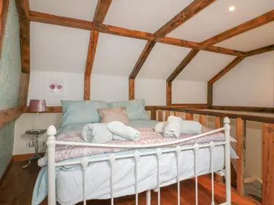 a bedroom with a bed with towels on it at Coinage Hall in Lostwithiel