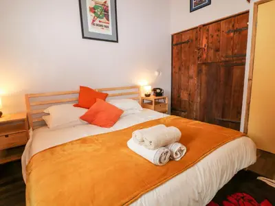 a bedroom with a bed with towels on it at Elvan Cottage in Liskeard