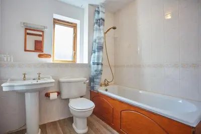 a bathroom with a toilet and a tub and a sink at Trevells in Wadebridge