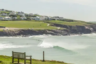 a bench sitting on a hill overlooking the ocean at Trevells in Wadebridge