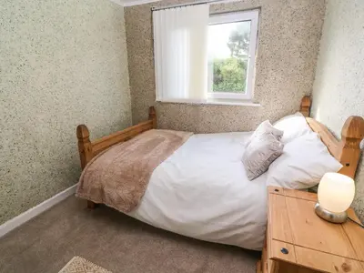 a bedroom with a bed and a window at Valhalla in St Ives