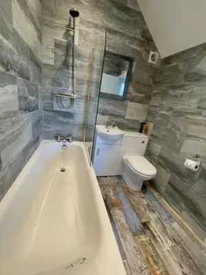 a bathroom with a bath tub and a toilet at Driftwood Seagrass in Par