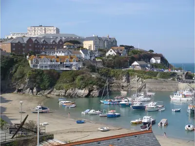 a group of boats docked in a harbor with houses at Harbour Hotel in Newquay