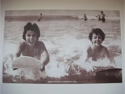 two women are in the water with a frisbee at Harbour Hotel in Newquay