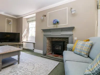 a living room with a couch and a fireplace at Culdrose Manor in Helston
