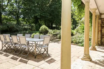 a table and chairs sitting on a patio at Culdrose Manor in Helston