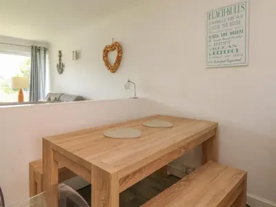 a wooden table sitting in a room with at 2 Europa Court in Newquay