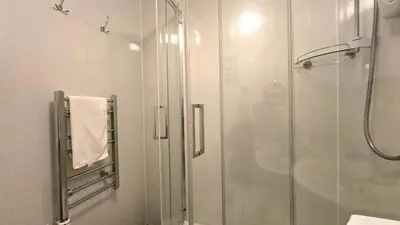 a bathroom with a shower and a glass shower stall at 10 Wheal Ramoth in Perranporth