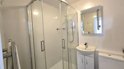 a bathroom with a shower and a sink at 10 Wheal Ramoth in Perranporth