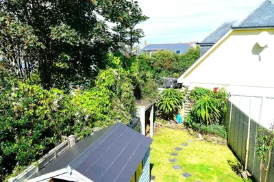 an aerial view of a house with a solar panel at Gwel Angarder in Perranporth