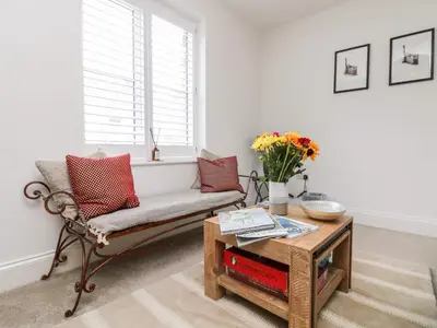 a living room with a couch and a table at Beacon House in St. Agnes