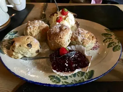 a plate of muffins and berries on a table at Holiday home, Camelford, Cornwall in Camelford