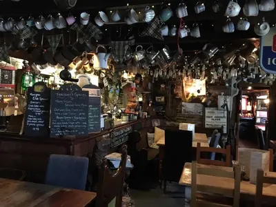 a restaurant with tables and chairs and a bar at Holiday home, Camelford, Cornwall in Camelford