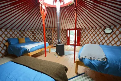 a room with two beds in a yurt at Glamping Yurts near Newquay in Newquay