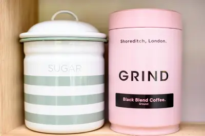 two pink jars sitting on a shelf at Luxury Coastal Shepherds Hut with hot tub, dining dome & a 5 Minute Walk to Pubs and Village in Polperro