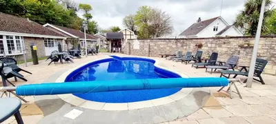 a swimming pool with a blue inflatable at Amazing Granite Henge and Swimming Pool in Looe