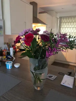a vase filled with flowers sitting on a table at 2 Lapwing Drive in Hayle