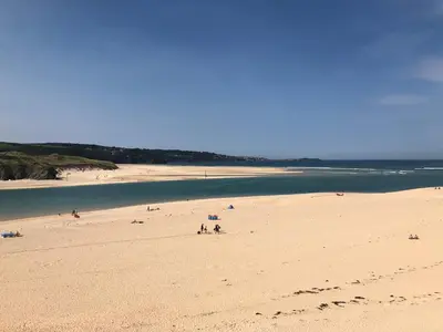 a group of people on a beach near the water at 2 Lapwing Drive in Hayle