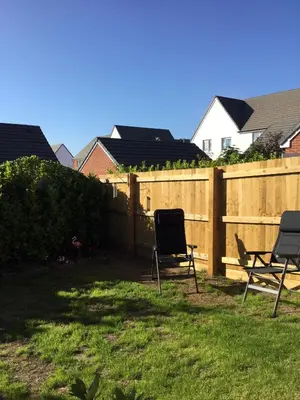 two chairs in a yard next to a fence at 2 Lapwing Drive in Hayle