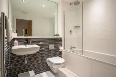 a bathroom with a toilet and a sink and a shower at Newquay Fistral Beach View in Newquay