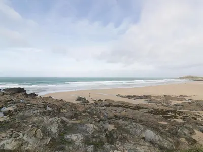 a view of a beach with rocks and the ocean at Newquay Fistral Beach View in Newquay