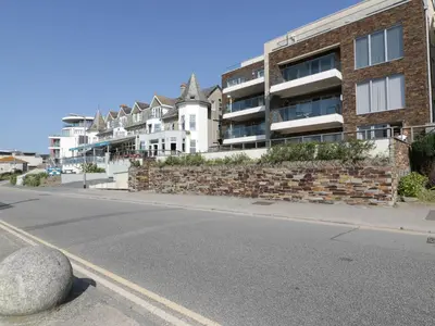 an empty street in front of a brick building at Newquay Fistral Beach View in Newquay