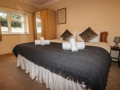a bedroom with a large bed with white pillows at Gwel An Mor in Newquay