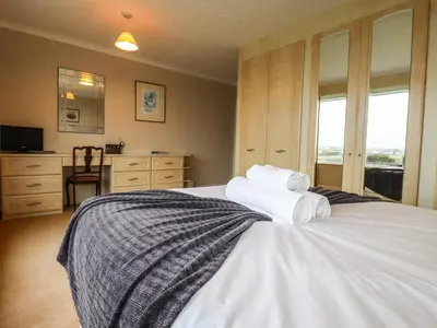 a bedroom with a bed with towels on it at Gwel An Mor in Newquay