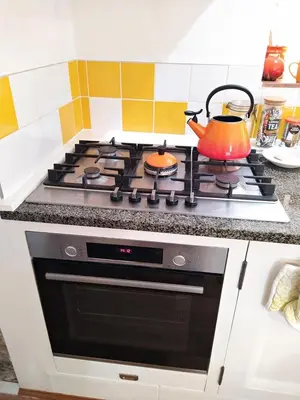 a kitchen with a stove with a tea pot on it at The Shire House in Lostwithiel