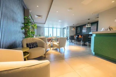a waiting room with chairs and a table in a building at Polzeath Beach House in Polzeath