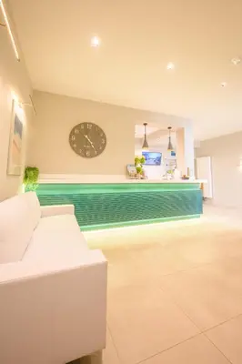 a living room with a clock on the wall at Polzeath Beach House in Polzeath