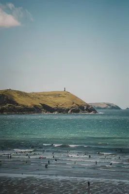 a group of people in the water at the beach at Polzeath Beach House in Polzeath