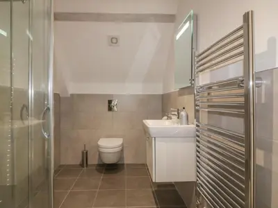 a bathroom with a toilet and a sink and a shower at Stores & Supplies in Bodmin